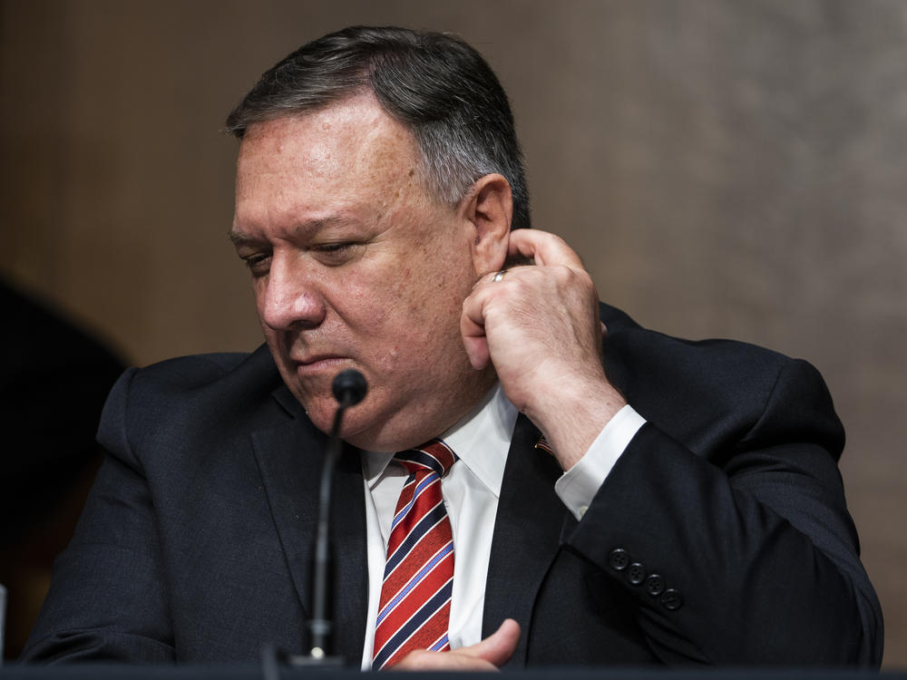 Secretary of State Mike Pompeo testifies before a Senate Foreign Relations Committee hearing in July. The State Department has lifted its global health advisory warning against international travel.