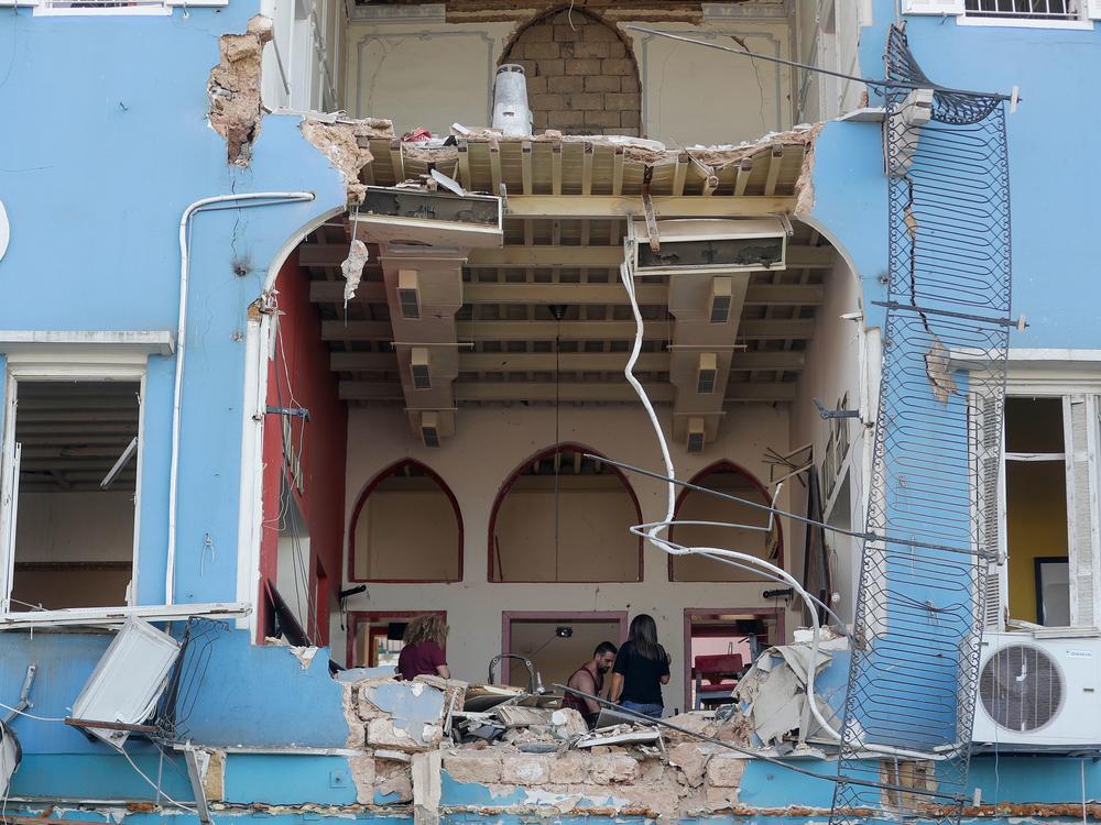 On Wednesday, a Lebanese couple inspects the damage to their house in an area overlooking the destroyed Beirut port the day before.