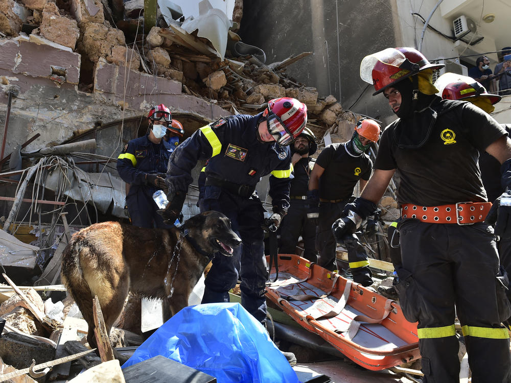 Search and rescue workers sift through damaged buildings Thursday in Beirut after this week's huge explosion at the Lebanese capital's port caused widespread damage.