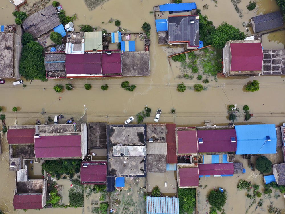 An aerial photo shows the extent of flooding in Guzhen Town of Lu'an City in eastern China's Anhui province on July 20.