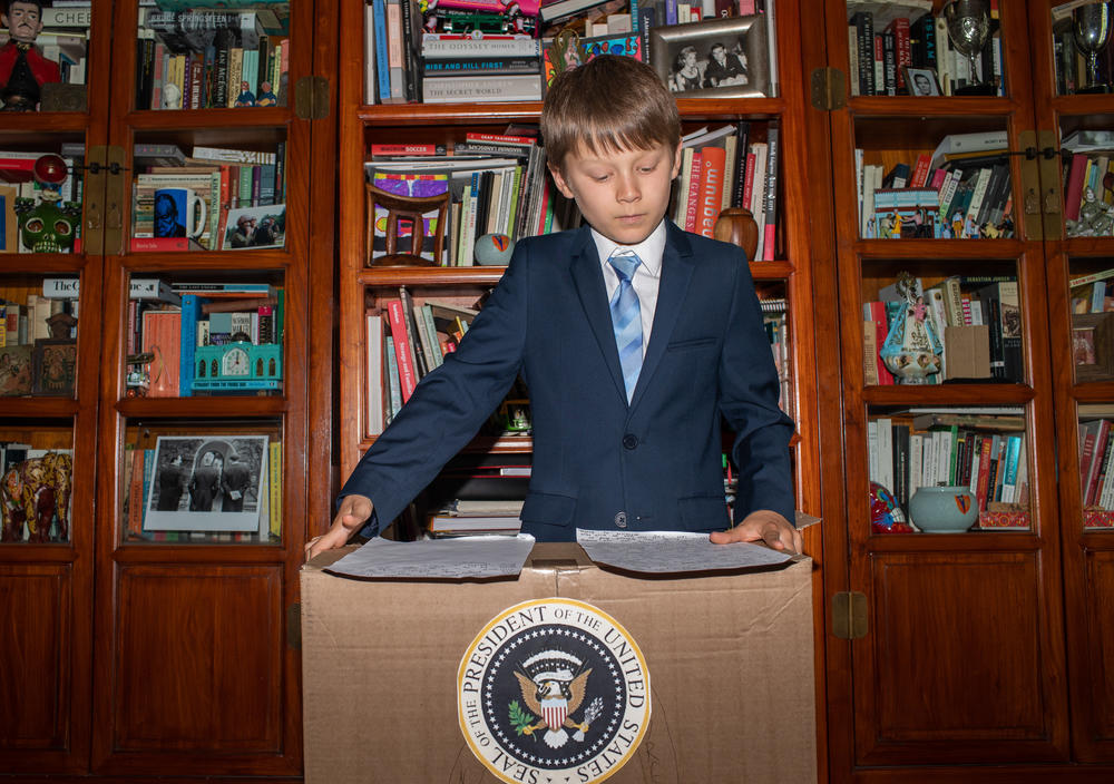 Ben, 10, revises his notes on the Gettysburg Address from a presidential cardboard podium.