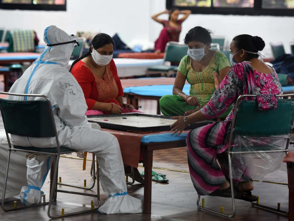 Coronavirus patients play a game of carrom inside the COVID-19 Care Centre at CWG Village Sports Complex in New Delhi on Thursday.