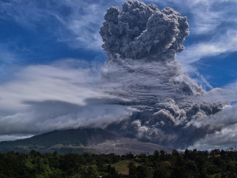 Mount Sinabung on Indonesia's Sumatra Island spews thick ash and smoke miles into the sky on Monday.