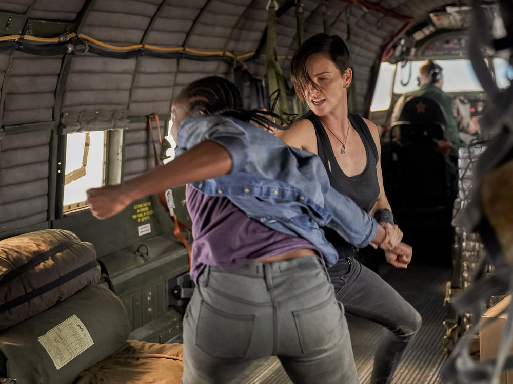 Nile (Kiki Layne) and Andy (Charlize Theron) fight in <em>The Old Guard</em>. Gina Prince-Bythewood says her experiences as a kickboxer helped her choreograph the movie's fight scenes: 
