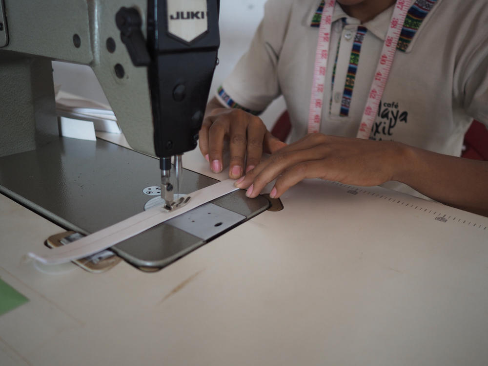 Workers at Maya Ixil have pivoted from sewing beekeeper's clothing to making face masks in the cooperative's workshop.
