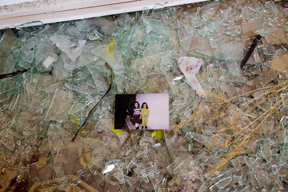 A family photo of Karen Madi (left) and her sister Stephanie found on top of shattered glass. 