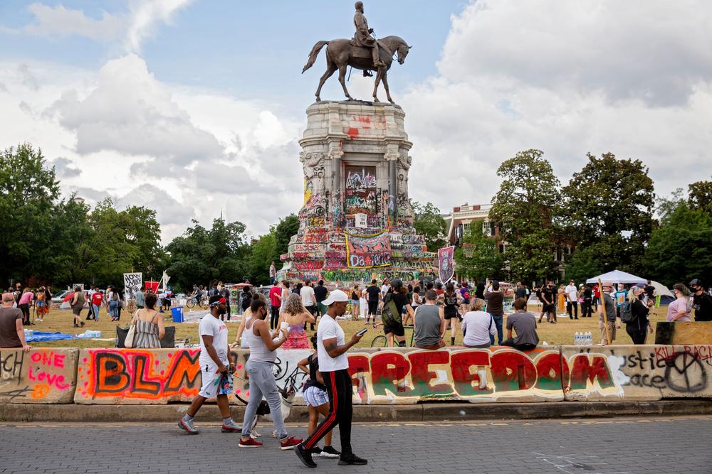 People gather around the Robert E. Lee statue on Monument Avenue in Richmond, Va., on June 20, 2020.