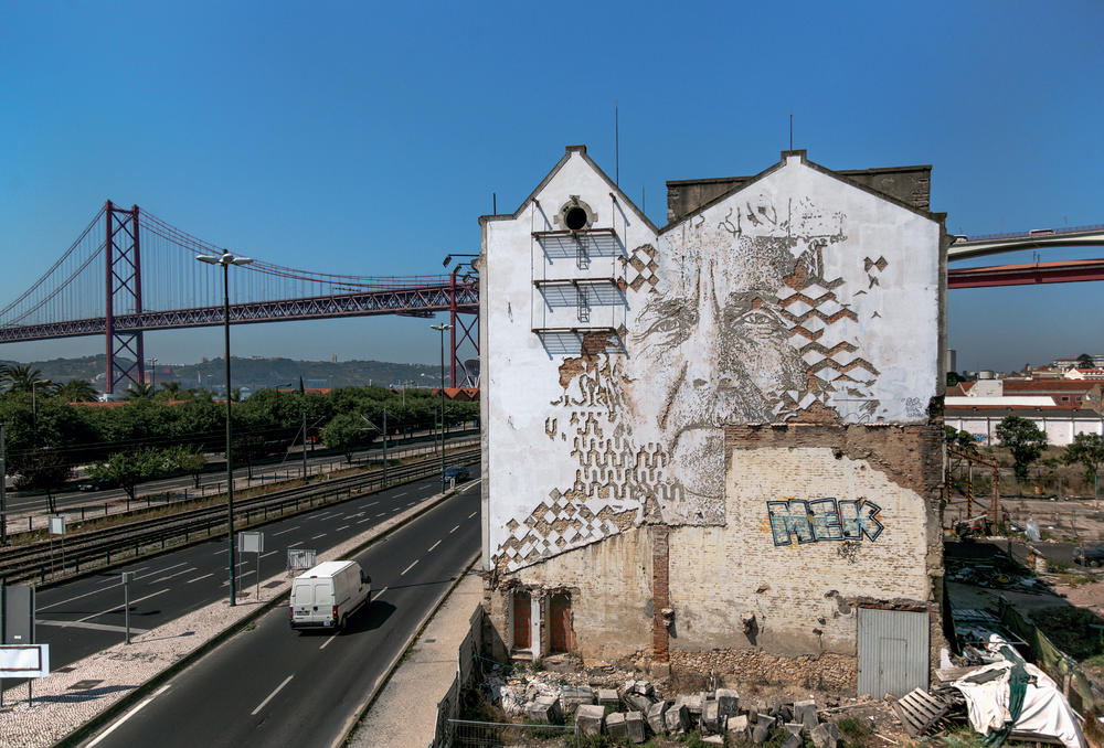 Vhils finds faces in walls — like this one in Lisbon, Portugal, in 2014.