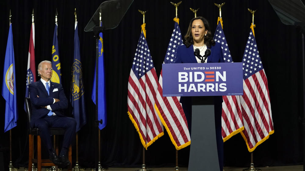 Biden listens as Harris speaks during their introductory event Wednesday at Alexis I. duPont High School.