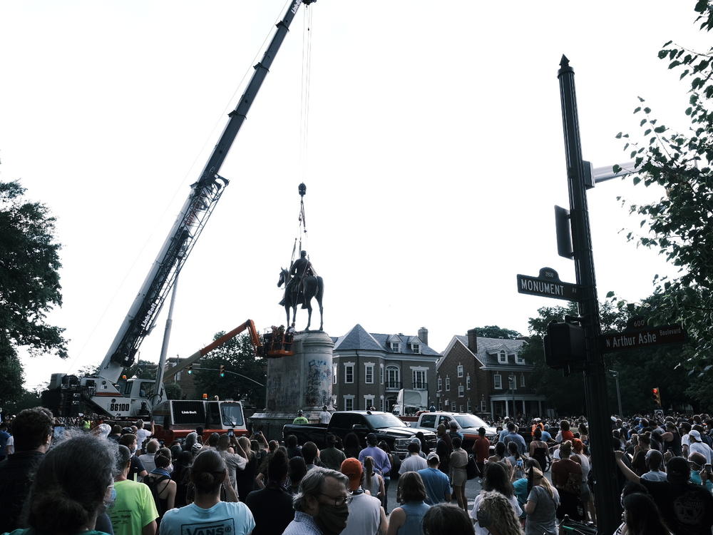 A crowd watches as a crane removes the Stonewall Jackson Monument in Richmond, Va., on July 1. Dozens of Confederate monuments have come down this summer.