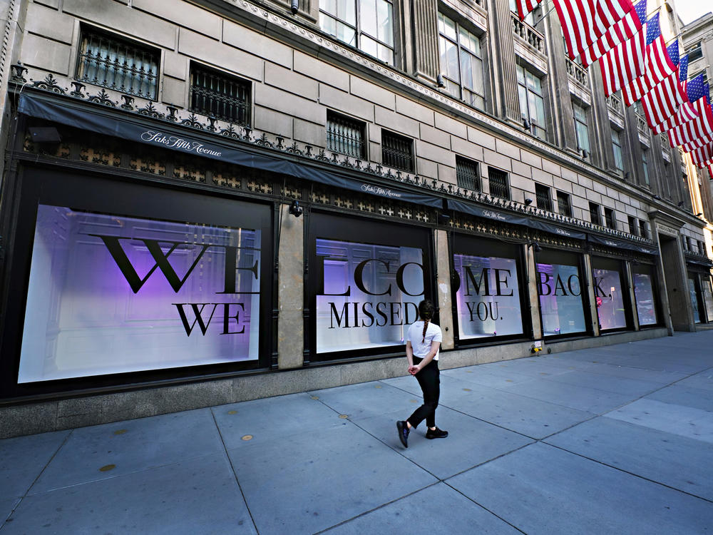 A pedestrian walks by Saks Fifth Avenue as New York City continues relaxing more restrictions imposed to curb the coronavirus pandemic.