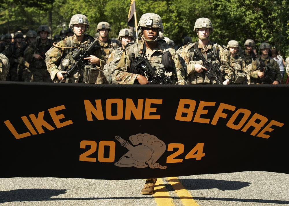 Senior Evan Walker, cadet basic training commander, marches with freshmen as they display their motto on a 12-mile march after finishing up four weeks of basic training on Monday in West Point, N.Y.