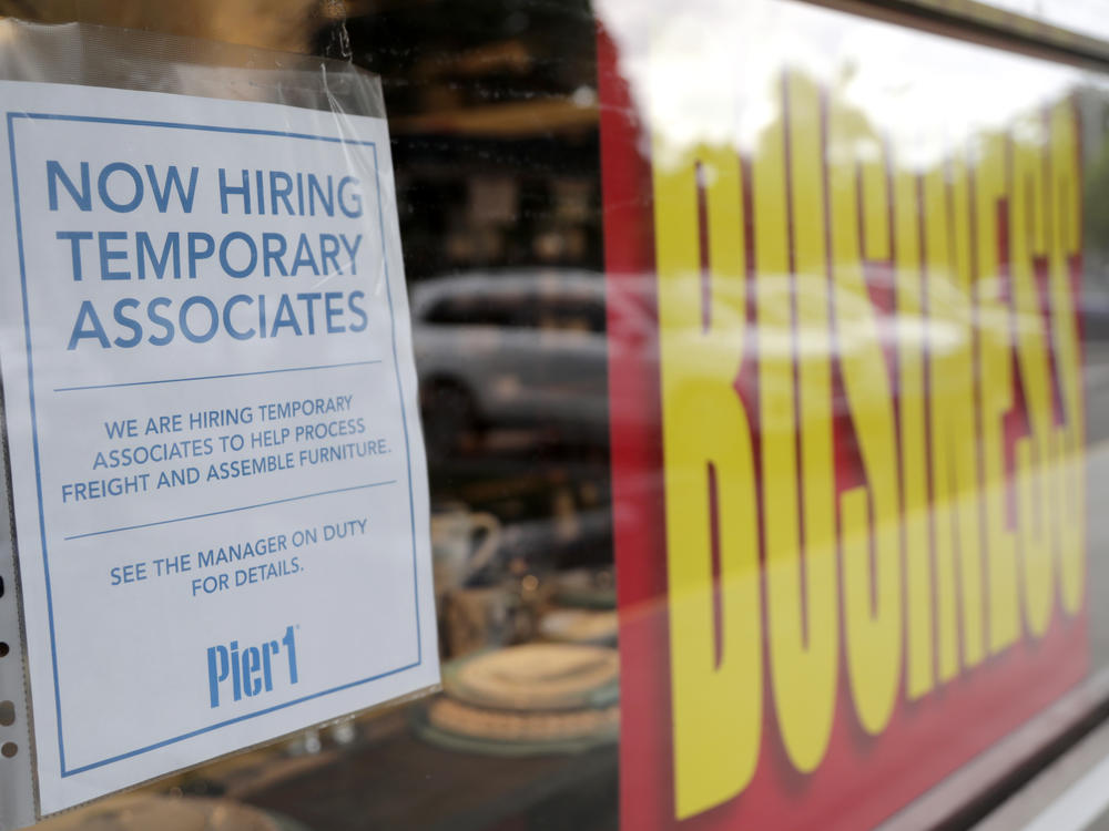 A sign advertises hiring of temporary workers at a Pier 1 store that's going out of business in Coral Gables, Fla. Last week, initial unemployment claims broke a 20-week streak of being above 1 million.