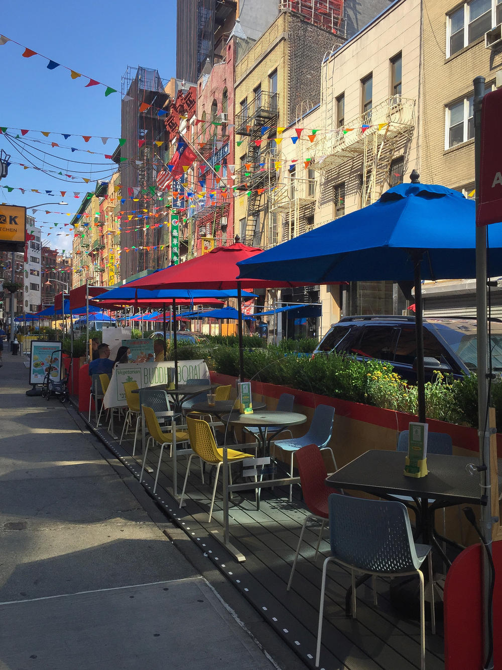 Many streets in New York City's Chinatown have narrow sidewalks. The Chinatown Business Improvement District restricted traffic on this street and created outdoor dining space.