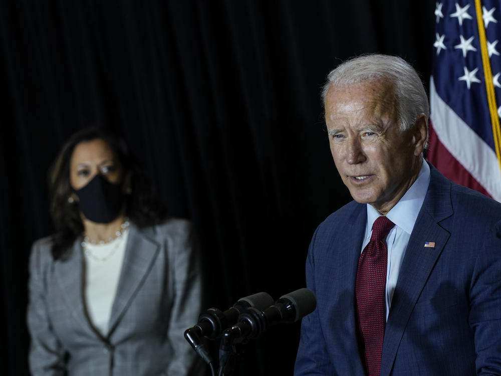 Presumptive Democratic presidential nominee Joe Biden speaks Thursday after a coronavirus briefing with health experts and his newly named running mate, Sen. Kamala Harris, at the Hotel DuPont in Wilmington, Del. Biden took off his mask to speak.