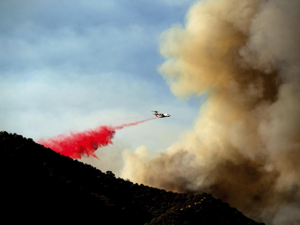 An air tanker drops retardant as the Lake Fire burns in the Angeles National Forest north of Santa Clarita, Calif., on Thursday.