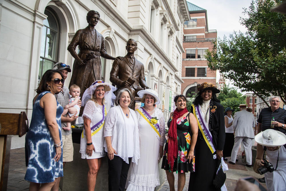 Suffrage Coalition President Wanda Sobieski (third from right, in suffrage regalia) and other coalition members pose with the statue of Febb and Harry Burn at the unveiling of the Burn Memorial in Knoxville, Tenn., in June 2018.