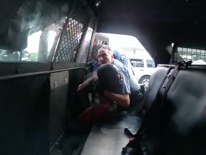 Minneapolis Officer Derek Chauvin is seen struggling to force George Floyd into the back seat of a police SUV in newly released body camera video recorded by Officer Tou Thao. Both Chauvin and Thao were fired, along with two other officers involved in Floyd's death on Memorial Day. All four former officers are facing charges.