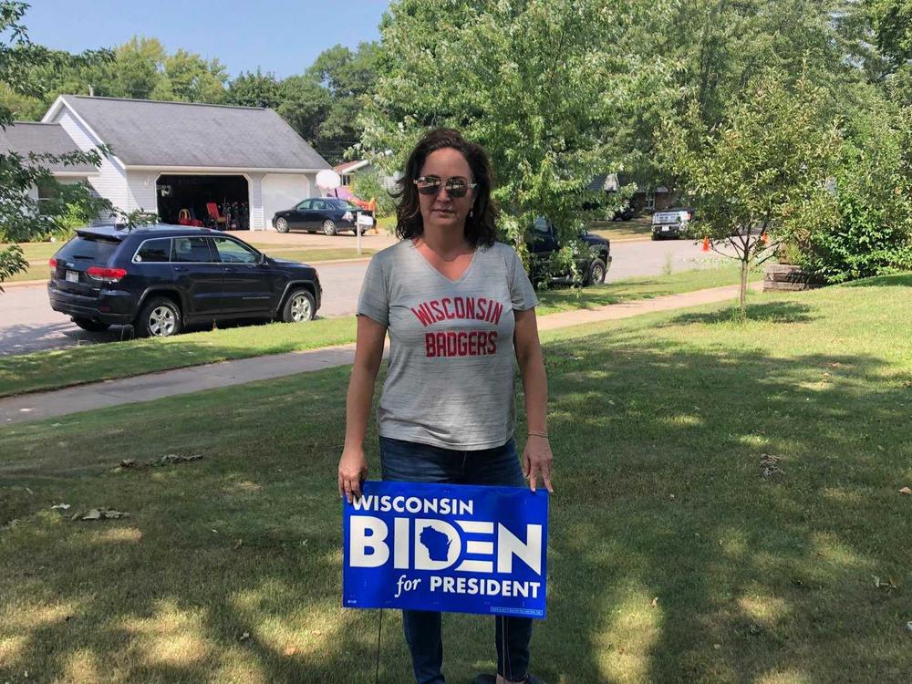 Instead of attending the Democratic National Convention in person, Bobbi Green is volunteering and handing out Joe Biden yard signs in Eau Claire, Wis.