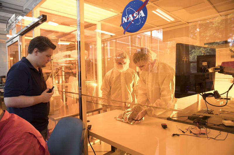 Some students of the 50-member lab test their designs in the clean room.