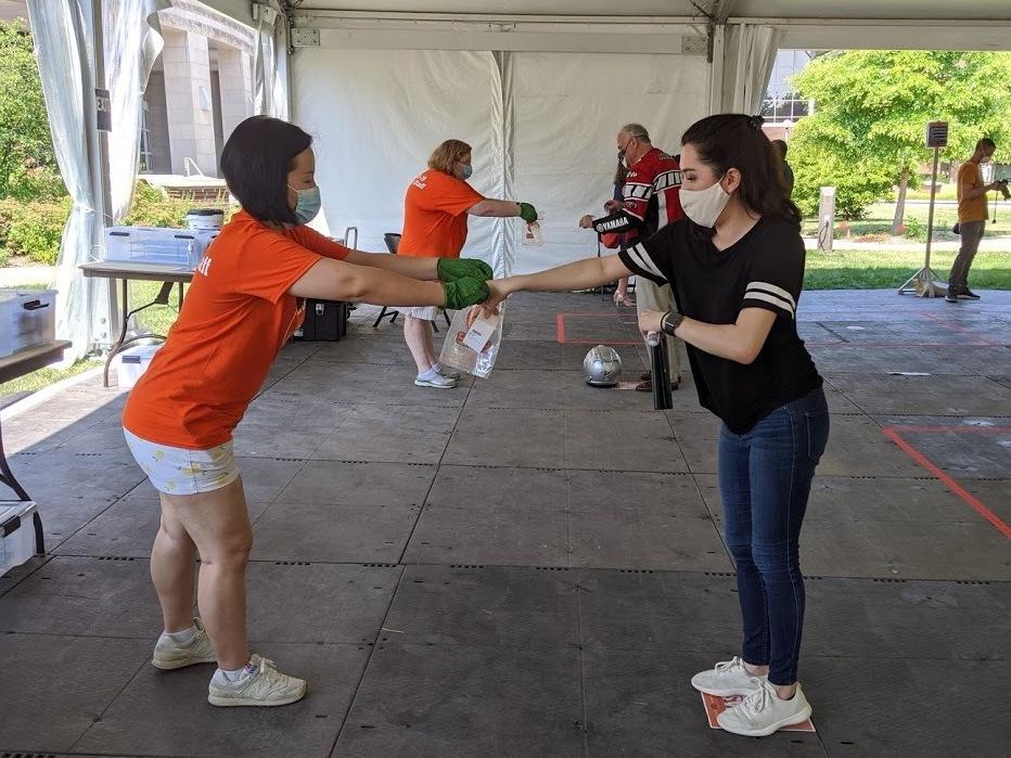 University of Illinois graduate student Kristen Muñoz submits her saliva sample for coronavirus testing on the Urbana-Champaign campus.