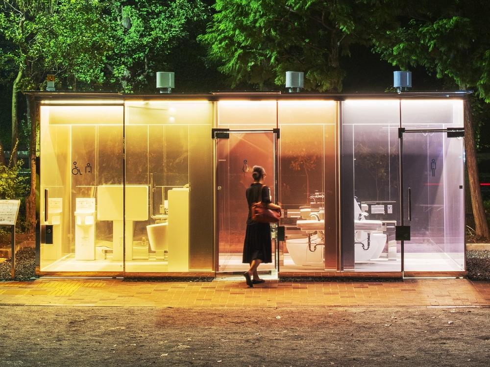 A woman enters a public restroom with transparent walls in Tokyo's Shibuya ward. Architect Shigeru Ban designed the bathroom in a way to reassure anyone entering the toilet.