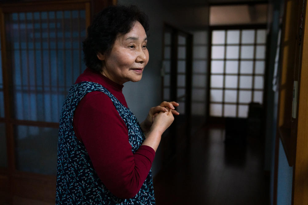 Yuriko Kanno, 75, is amused by the battle between her husband and the monkeys.