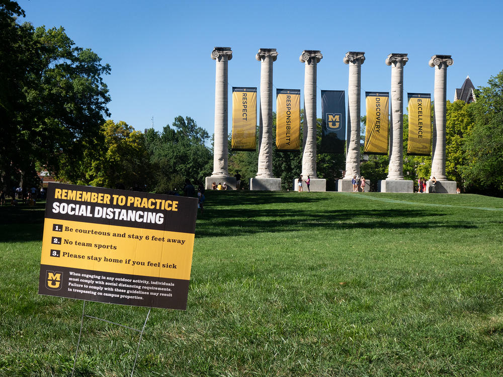 A sign on the Francis Quadrangle at the University of Missouri in Columbia reminds students to maintain social distancing.