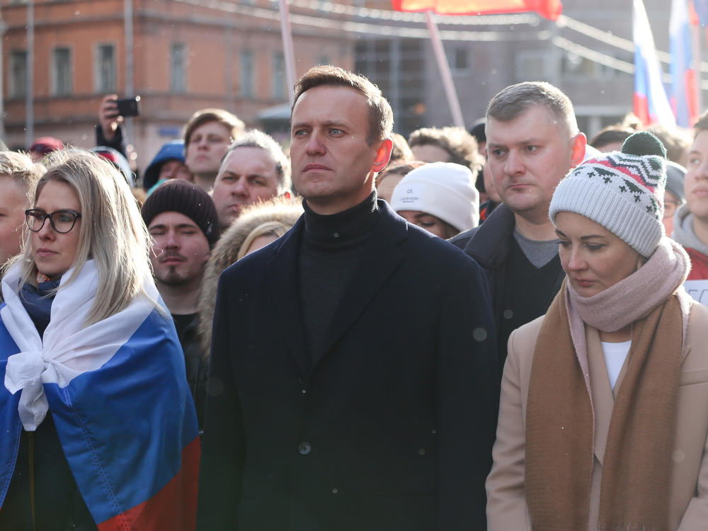 Alexei Navalny is seen during a rally in Moscow last year along with his wife, Yulia (right). She and his personal doctor were reportedly prevented from seeing him in the hospital.