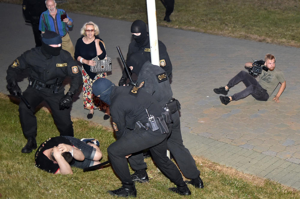 Riot police loom over a demonstrator during a protest after polls closed in Belarus' presidential election, in Minsk on Aug. 9. Human rights groups have alleged that Belarusian authorities used torture against peaceful protesters.