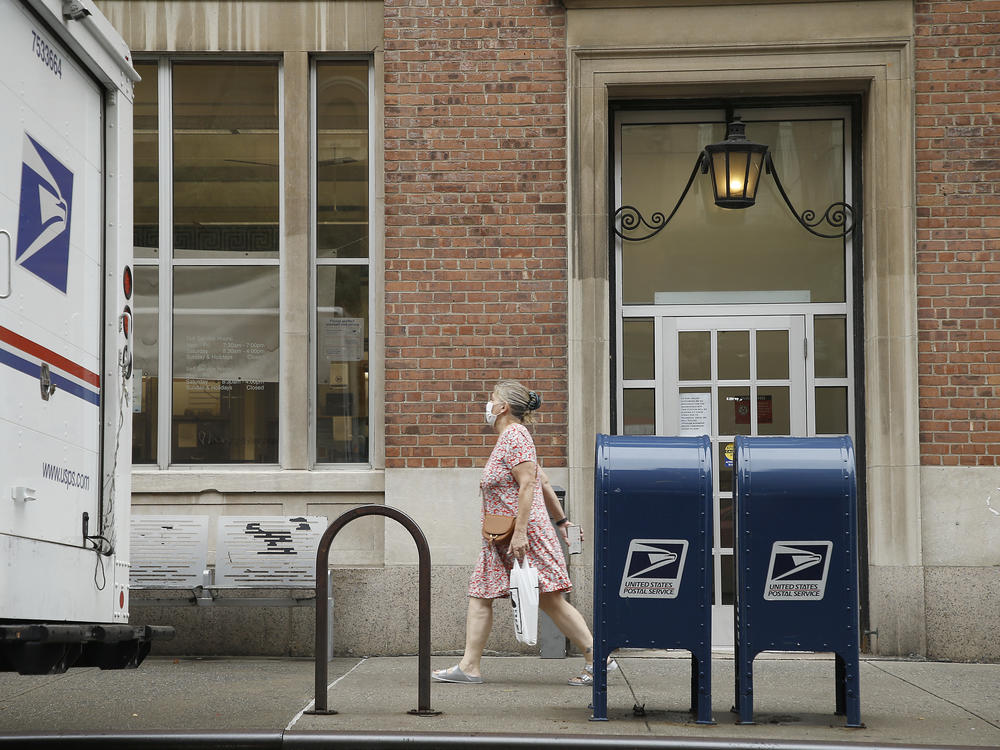 A woman walks past two mailboxes near a post office this week in New York City.