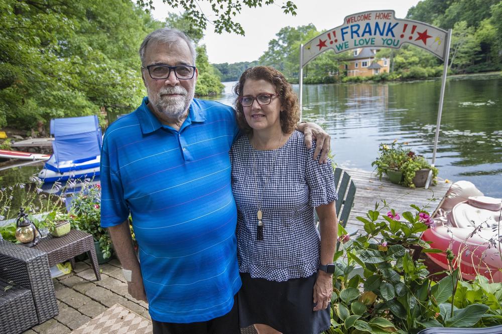 Frank and Leslie Cutitta at their home in Wayland, where a banner still hangs for his return from the hospital.