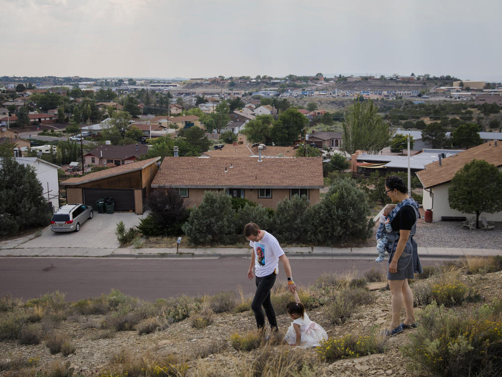 Dr. Chris Hoover (left) and Dr. Connie Liu (right) walk through their home with their children Taro, 3, and Hiro, 4 months, in Gallup, N.M. On a short reporting trip across the Southwest, NPR met very different families and asked them the same simple question: What's been keeping you at night?