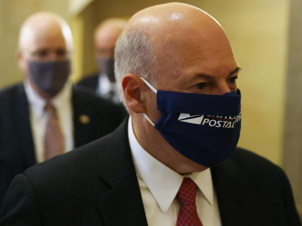 Postmaster General Louis DeJoy, pictured at the U.S. Capitol on Aug. 5, denies any slowdowns at the U.S. Postal Service are part of any attempt to reduce voting by mail this year.