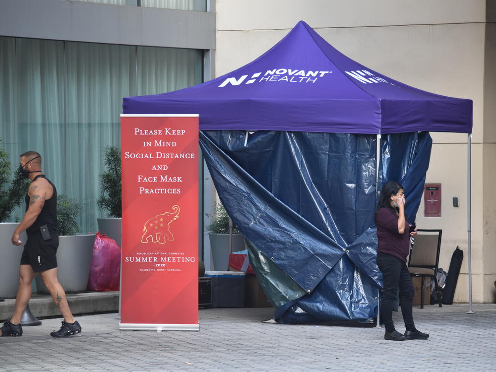 Convention attendees must get a coronavirus test upon arrival and carry badges that record their movements.