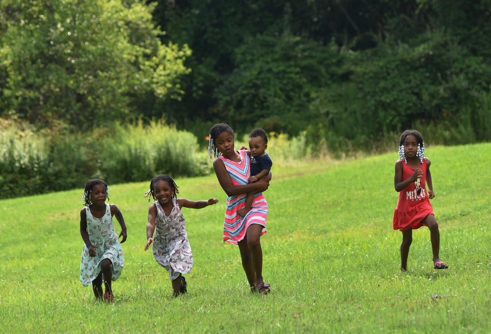 Kwanasia Ginyard (left), Gianna Bridges, Kamani Minton, Shevin Fanklin, Jr., and Micaela Johnson play in their great-grandfather's yard during his 85th birthday celebration.