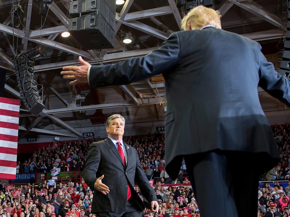 President Trump greets talk show host Sean Hannity at a 2018 rally in Cape Girardeau, Mo.