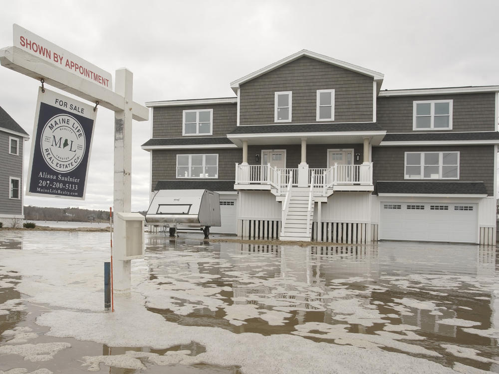 Floodwaters surround a newly constructed house for sale in Maine in 2018. Realtor.com added flood risk information to the more than 100 million listings on its site.