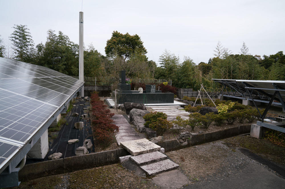 Hiroyuki Endo's grave sits in the middle of the solar farm he and his family built after fleeing Fukushima.