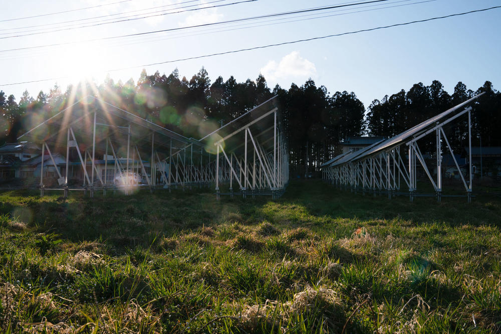 Solar panels in Konno's field in Iitate, a community in Fukushima Prefecture once known for producing rice and beef. The wind carried high amounts of radioactive material here after the disaster, and the government scraped off all the topsoil in decontamination efforts, making farming a challenge.