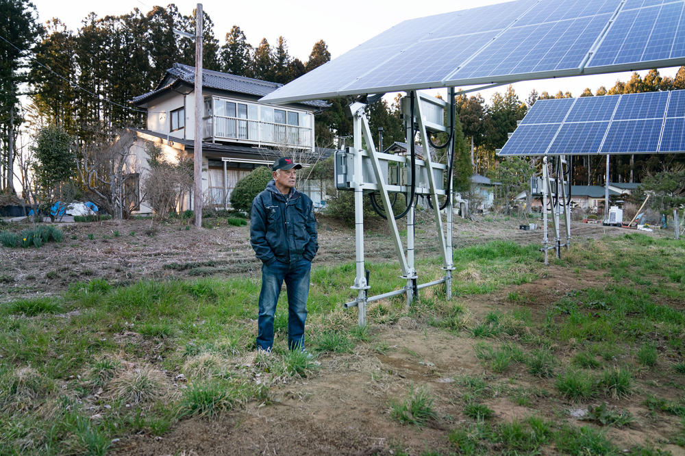 Shigeyuki Konno, 74, stands outside his home where he rents his land out for a power company to install solar panels.