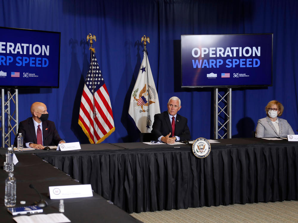 FDA Commissioner Stephen Hahn (left), Vice President Mike Pence, and Dr. Ella Grach, CEO of Wake Research, at the NC Biotechnology Center in July, where Phase 3 trials for a coronavirus vaccine candidate are underway.