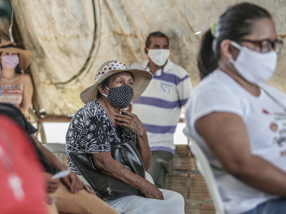 People wait for a flu vaccine in May in Manaus, Brazil. The flu season had a surprisingly low count of influenza cases in the Southern Hemisphere, and researchers are trying to figure out the role coronavirus precautions might have played.