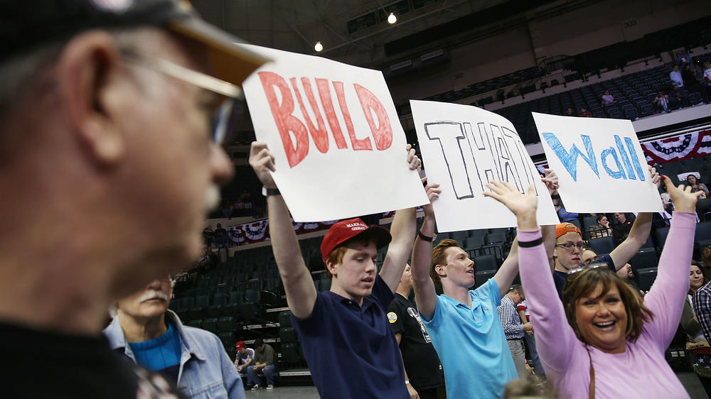 People hold signs that read 