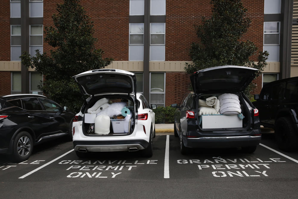 Students pack their belongings back into cars at Granville Towers, where one of the first clusters of positive coronavirus cases was <a href=