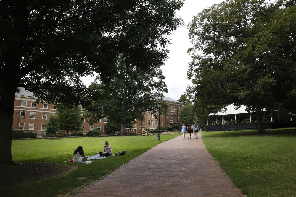 Students lounge on campus at the University of North Carolina at Chapel Hill. The university reported its first coronavirus clusters after a week of in-person classes.