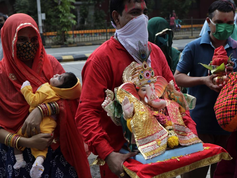 Devotees prepare to immerse in an artificial pond an idol of elephant-headed Hindu god Ganesh in Mumbai, India, Aug. 23. India's coronavirus caseload topped 3 million that day, with the country leading the world in new daily infections.
