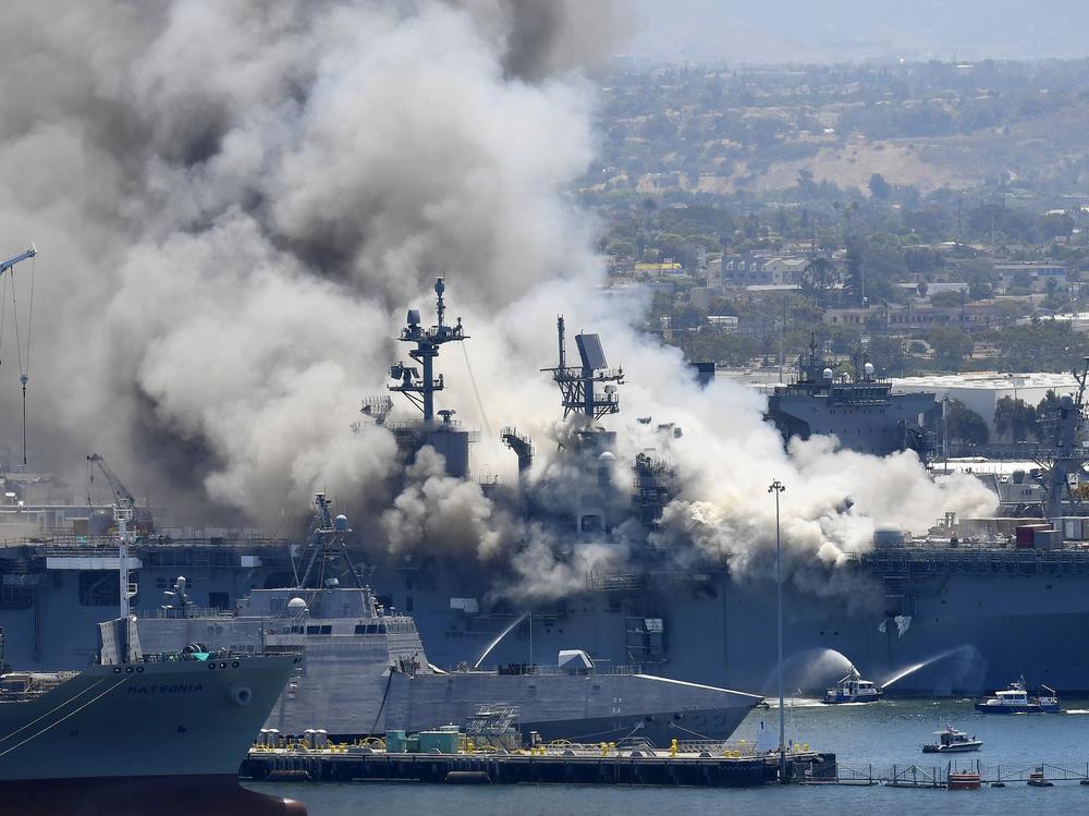 Smoke rises from the USS Bonhomme Richard after an explosion and fire on board the amphibious assault ship at Naval Base San Diego. The Navy is investigating whether the fire was due to arson.