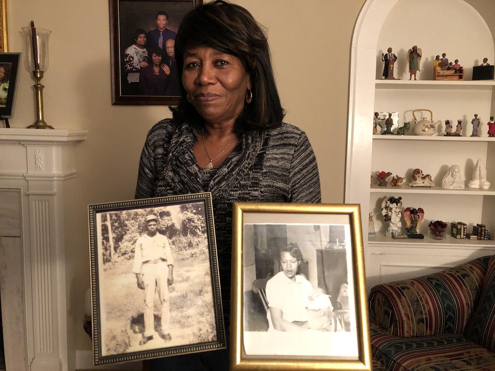 Deloris Melton Gresham in her home in Drew, Miss., holding photographs of her parents Clinton and Beulah Melton.