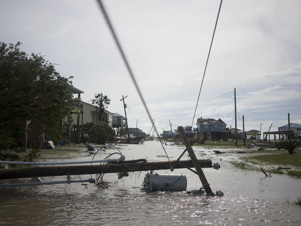 Damaged homes sit among floodwaters after Hurricane Laura passed through the area Thursday in Holly Beach, La.